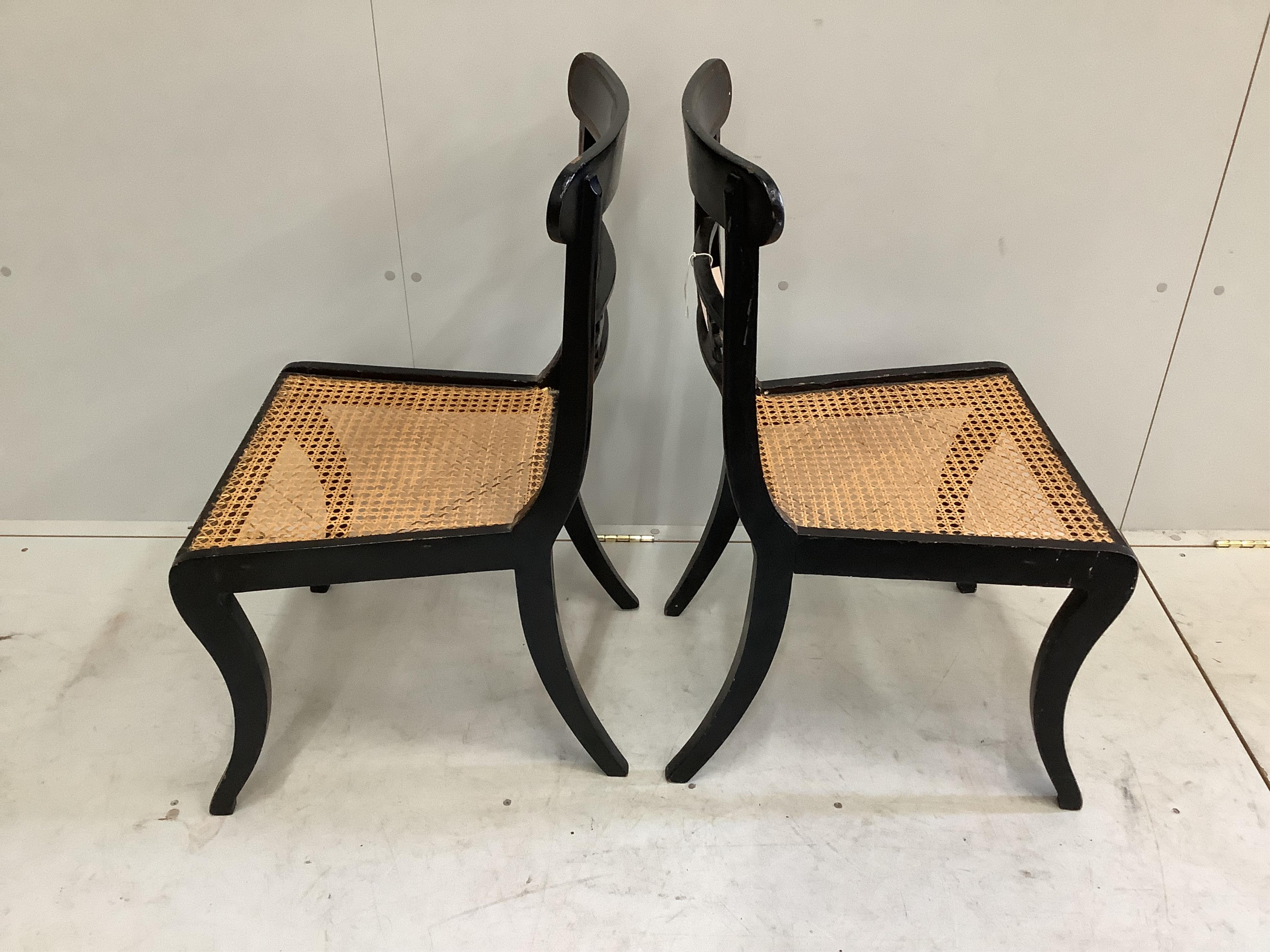 A pair of Regency painted parcelgilt cane seat dining chairs
